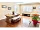 Bright dining area with a large window, hardwood floors, and modern bench-style seating at 2525 S Pennsylvania St, Denver, CO 80210