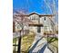Inviting two-story home featuring a secure, gated yard and a charming front patio area at 2525 S Pennsylvania St, Denver, CO 80210