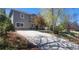 Well-manicured gray home with stone accents, a long drive, and mature landscaping at 2525 S Pennsylvania St, Denver, CO 80210