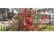 Charming home featuring vibrant red flowering bushes and a classic black iron fence at 2525 S Pennsylvania St, Denver, CO 80210