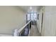 Well-lit hallway with stairs, white railings, arch window, and plant in the hall nook at 2525 S Pennsylvania St, Denver, CO 80210