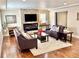 Comfortable living room featuring a stone fireplace, recessed lighting, and neutral-toned sofas at 2525 S Pennsylvania St, Denver, CO 80210