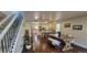 Open-concept living area with hardwood floors, dining table, stairs and views of the kitchen at 2525 S Pennsylvania St, Denver, CO 80210