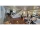 Spacious living area featuring hardwood floors, a stone fireplace and access to the kitchen and stairs at 2525 S Pennsylvania St, Denver, CO 80210