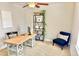 Home office with a ceiling fan, desk, modern shelving, and comfortable seating at 2525 S Pennsylvania St, Denver, CO 80210