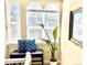 Bright window nook featuring a bench, throw pillows, and a bird of paradise plant at 2525 S Pennsylvania St, Denver, CO 80210