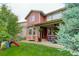 Well-maintained backyard features a lawn, playset and covered patio, perfect for outdoor enjoyment at 24686 E Florida Ave, Aurora, CO 80018