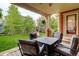 Covered patio with outdoor seating looking out to a backyard with a playground at 24686 E Florida Ave, Aurora, CO 80018