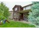 Inviting backyard with a covered patio perfect for outdoor dining and relaxing with a grassy area and a play structure at 24686 E Florida Ave, Aurora, CO 80018
