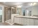 Stylish bathroom with a glass-enclosed shower, double sink vanity, and tiled floors providing a luxurious feel at 24686 E Florida Ave, Aurora, CO 80018