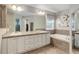 Spacious primary bathroom with double sinks, soaking tub, and tile accents at 24686 E Florida Ave, Aurora, CO 80018