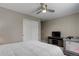 Neutral bedroom featuring a ceiling fan, closet, TV, and crib at 24686 E Florida Ave, Aurora, CO 80018