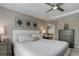 Comfortable bedroom featuring ceiling fan and ensuite bathroom access at 24686 E Florida Ave, Aurora, CO 80018