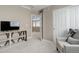 Bonus room with a TV console table and a cozy chair near a landing overlooking the floor below at 24686 E Florida Ave, Aurora, CO 80018