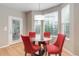 Bright breakfast nook with a glass table, seating for four, and door to the exterior at 24686 E Florida Ave, Aurora, CO 80018