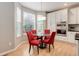 Sunlit breakfast nook with a glass table and seating for four at 24686 E Florida Ave, Aurora, CO 80018