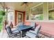 Inviting covered patio features a cozy seating area with an outdoor fire pit table, and view of the yard at 24686 E Florida Ave, Aurora, CO 80018