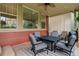 Inviting covered patio features a cozy seating area with an outdoor fire pit table and ceiling fan at 24686 E Florida Ave, Aurora, CO 80018