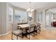 Open-concept dining room with wood floors, large windows, and seating for six at 24686 E Florida Ave, Aurora, CO 80018