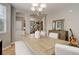 Neutral dining area with seating for six at a large table plus view of the home's entry and stairway at 24686 E Florida Ave, Aurora, CO 80018