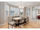 Bright dining room with hardwood floors and a view into the living room through an arched opening at 24686 E Florida Ave, Aurora, CO 80018
