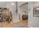 Open entryway featuring hardwood floors, a staircase, and an arched doorway at 24686 E Florida Ave, Aurora, CO 80018