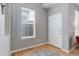 Bright entryway with a window and white door on hardwood floors at 24686 E Florida Ave, Aurora, CO 80018