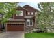 Charming two-story home with brown siding, stone accents, and a two-car garage at 24686 E Florida Ave, Aurora, CO 80018