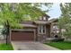 Charming two-story home with brown siding, stone accents, and a two-car garage at 24686 E Florida Ave, Aurora, CO 80018