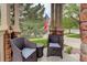 Inviting front porch seating area with comfortable chairs and a small table at 24686 E Florida Ave, Aurora, CO 80018