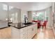 Bright, modern kitchen features an island with seating and a breakfast nook at 24686 E Florida Ave, Aurora, CO 80018