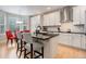 Bright kitchen with white cabinets, granite countertops, an island with bar stools, and a breakfast nook at 24686 E Florida Ave, Aurora, CO 80018