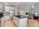 Open concept kitchen featuring a black countertop island, stainless steel appliances, and hardwood floors at 24686 E Florida Ave, Aurora, CO 80018