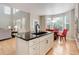 Open concept kitchen with island and eat-in kitchen area with a round glass table and seating for four at 24686 E Florida Ave, Aurora, CO 80018