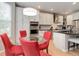 Bright kitchen with a round table, red chairs, stainless steel appliances, and white cabinetry at 24686 E Florida Ave, Aurora, CO 80018