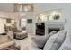 Open-concept living room with fireplace, shelving, and view of kitchen at 24686 E Florida Ave, Aurora, CO 80018