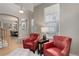 Cozy living room with hardwood floors, comfortable red armchairs, and ample natural light at 24686 E Florida Ave, Aurora, CO 80018