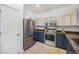 Well-lit kitchen with stainless steel appliances and a granite countertop finish at 6390 S Xanadu St, Englewood, CO 80111