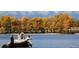 Scenic lake view featuring the lake water, distant trees and snowy mountains in the background at 6390 S Xanadu St, Englewood, CO 80111