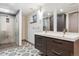 Basement bathroom with a glass shower, patterned flooring, and double vanity at 19739 E Wagontrail Dr, Centennial, CO 80015