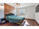 Bedroom featuring a wood accent wall, hardwood floors, and a window at 19739 E Wagontrail Dr, Centennial, CO 80015