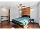 Stylish bedroom featuring a wood accent wall, hardwood floors, and a modern ceiling fan at 19739 E Wagontrail Dr, Centennial, CO 80015