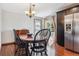 Cozy dining room with hardwood floors, black furniture, stainless steel appliances and a window at 19739 E Wagontrail Dr, Centennial, CO 80015