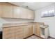 Bright laundry room featuring upper and lower cabinets, plus durable countertops for folding at 19739 E Wagontrail Dr, Centennial, CO 80015