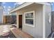 Storage shed with wooden access ramp, a white framed window and durable gray siding at 19739 E Wagontrail Dr, Centennial, CO 80015