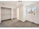 Bedroom with large window, closet, and adjacent bathroom at 5951 Oneida St, Commerce City, CO 80022