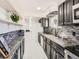 Open kitchen layout with granite countertops, mosaic backsplash, and modern appliances at 5951 Oneida St, Commerce City, CO 80022