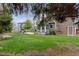 Exterior view of a home with a large backyard, patio, and lush green grass at 11615 E Maplewood Ave, Englewood, CO 80111