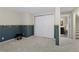 Spacious basement area with neutral carpet, bi-fold closet, and access to bathroom at 11615 E Maplewood Ave, Englewood, CO 80111