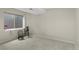 Basement room featuring carpet, two chairs, and a window with a view to the outside at 11615 E Maplewood Ave, Englewood, CO 80111